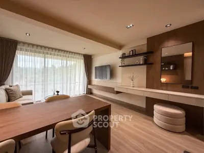 Modern living room with elegant decor and large windows offering natural light.