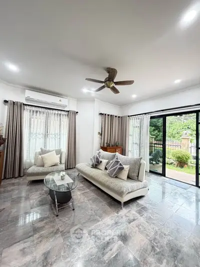 Spacious living room with modern decor and garden view