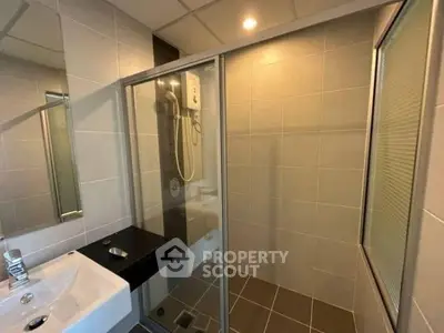 Modern bathroom with glass shower enclosure and sleek fixtures