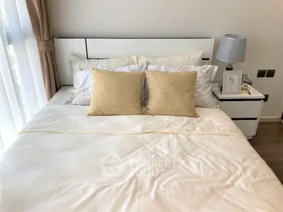 Elegant bedroom with cozy bedding and modern decor, perfect for relaxation.