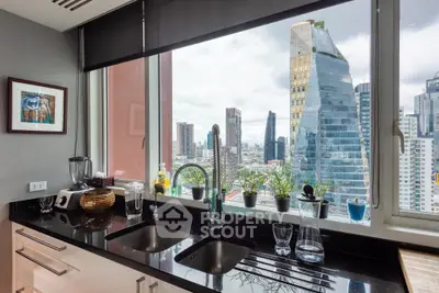 Modern kitchen with stunning city view, featuring sleek black countertops and large window.
