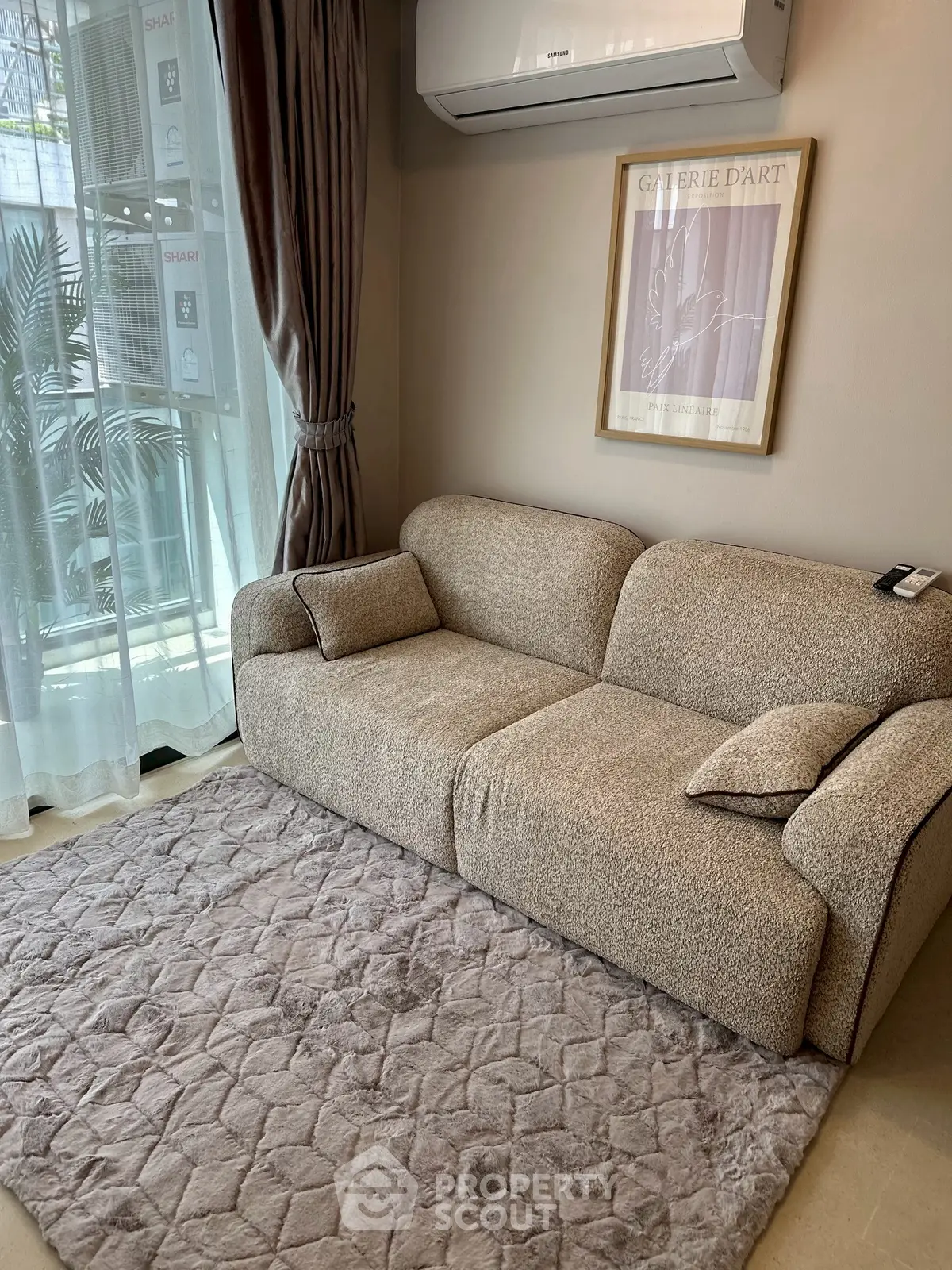 Cozy living room with plush sofa and elegant decor, perfect for relaxation.