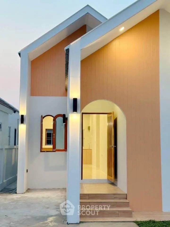 Charming modern house entrance with warm lighting and stylish architecture