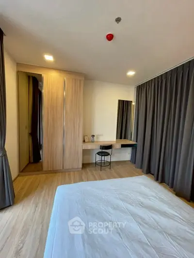 Spacious bedroom with modern decor and ample natural light