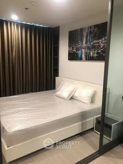 Modern bedroom with stylish decor and floor-to-ceiling curtains in a cozy apartment.