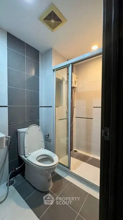 Modern bathroom with sleek tiles and glass shower enclosure
