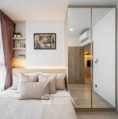 Modern bedroom with mirrored wardrobe and cozy decor
