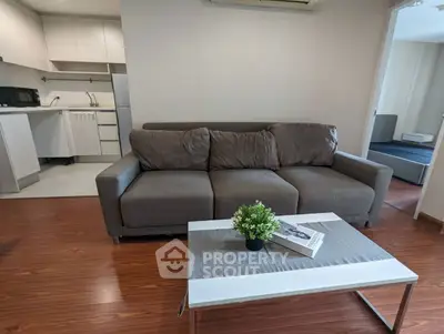 Modern living room with cozy sofa and stylish coffee table in open layout apartment.