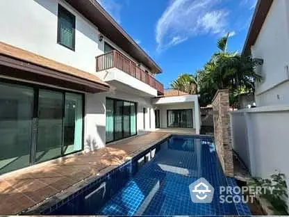 Modern villa with private pool and spacious balcony under clear blue sky