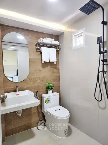 Modern bathroom with sleek fixtures and wood accent wall