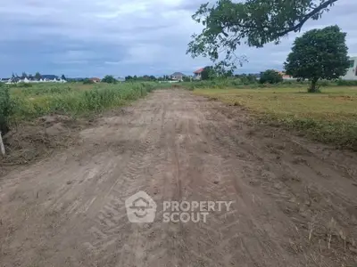 Expansive plot of land with clear skies, ideal for development opportunities.