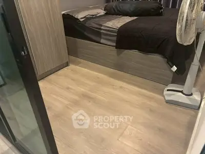 Cozy bedroom with wooden flooring and modern furnishings