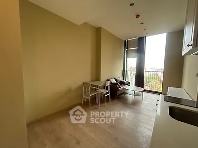 Modern living room with large windows and minimalist furniture, offering a bright and airy atmosphere.