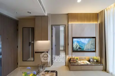 Modern living room with stylish decor and built-in TV unit, showcasing elegant interior design.
