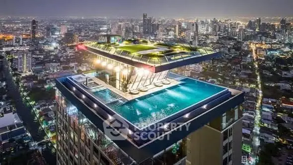 Stunning rooftop pool with panoramic city views at night, perfect for luxury living.