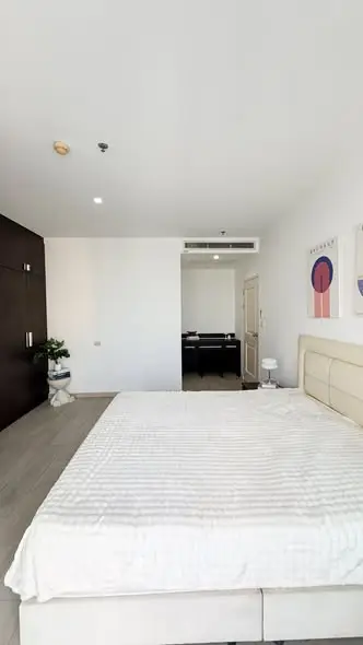 Spacious bedroom with modern decor and ample natural light