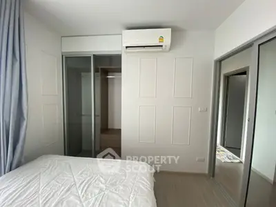 Modern bedroom with air conditioning and sliding closet doors