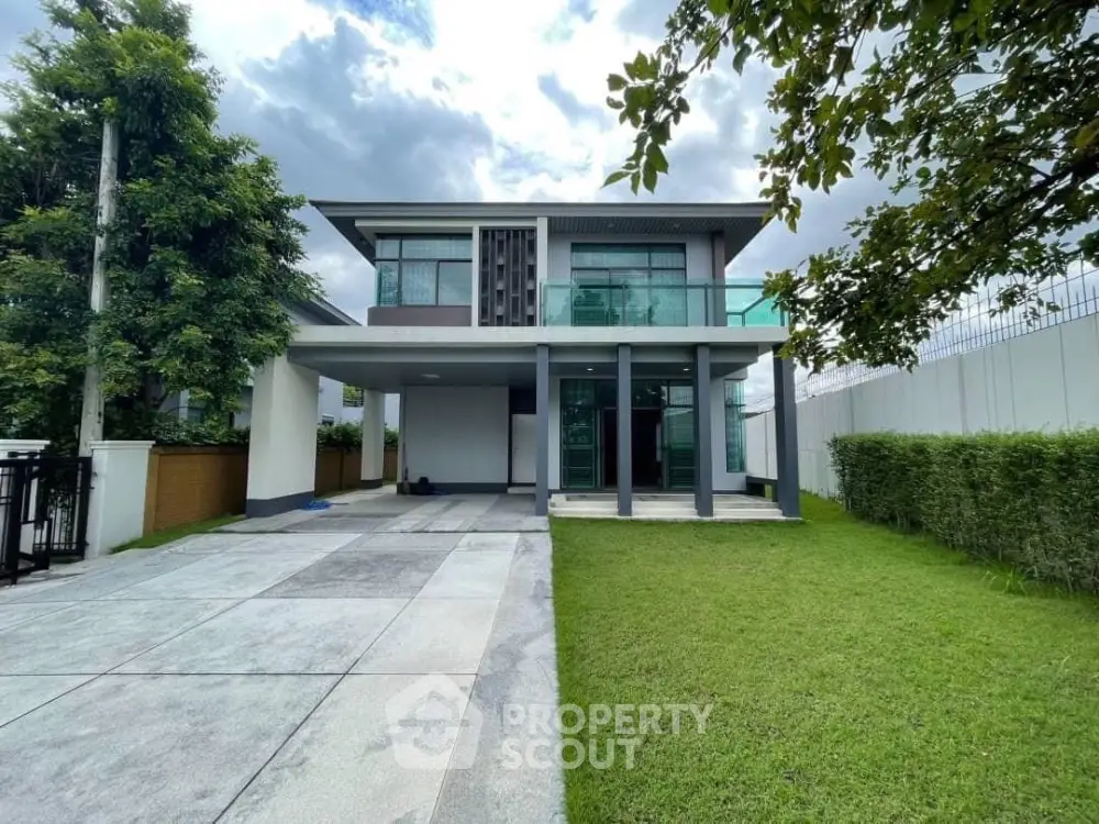 Modern two-story house with spacious driveway and lush green lawn