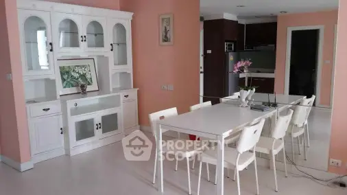 Spacious dining area with elegant white furniture and pastel walls