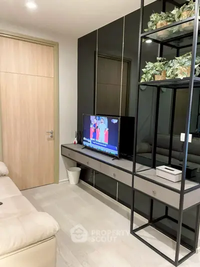 Modern living room with sleek black shelving and wall-mounted TV