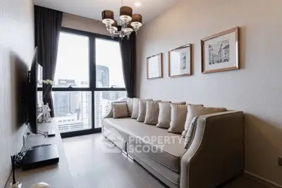 Modern living room with city view, elegant sofa, and stylish decor in high-rise apartment.