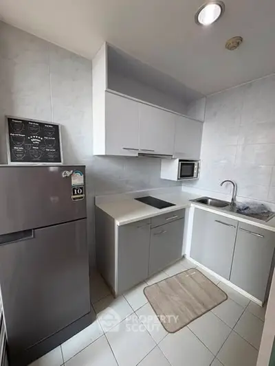 Modern compact kitchen with sleek cabinets and built-in appliances