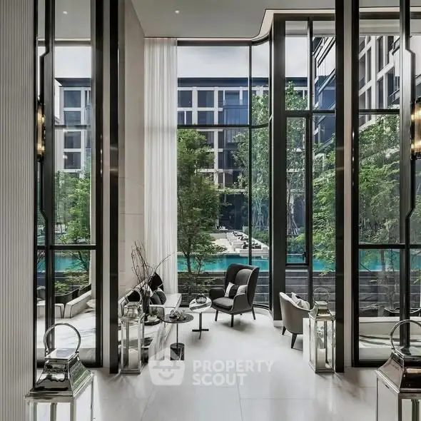 Luxurious modern living room with floor-to-ceiling windows overlooking a serene pool and lush greenery.