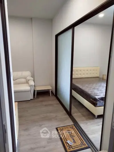 Modern bedroom with sliding glass doors and cozy seating area