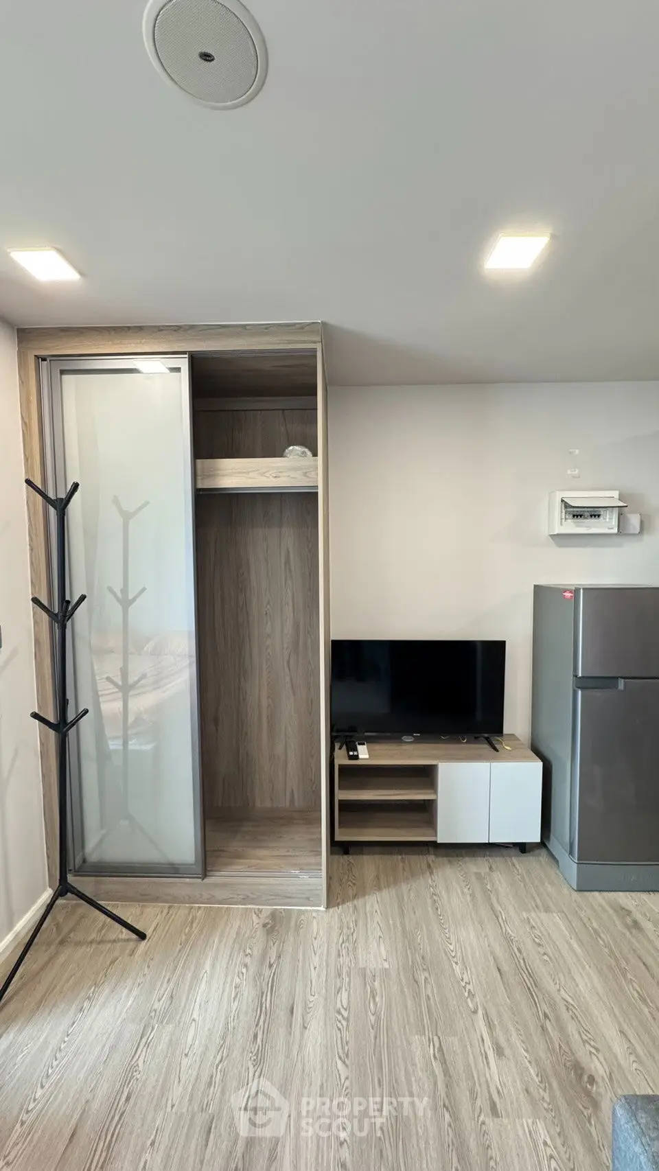 Modern living space with sleek TV unit and spacious wardrobe, perfect for urban living.