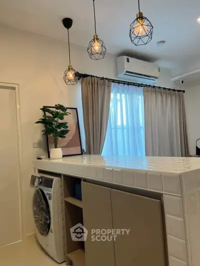 Modern kitchen with stylish lighting and built-in washing machine