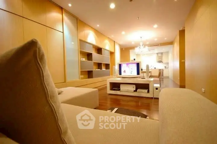 Spacious modern living room with open kitchen and elegant lighting