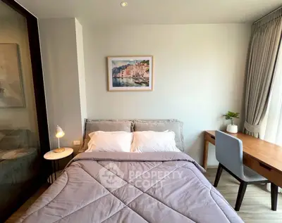 Cozy bedroom with modern decor, featuring a comfortable bed, stylish desk, and elegant lighting.