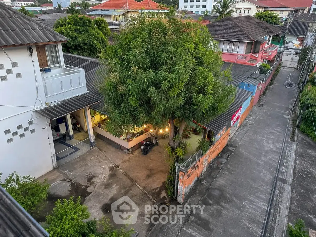 Charming residential property with lush greenery and spacious outdoor area in a serene neighborhood.