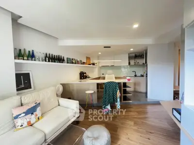 Stylish open-plan living room with modern kitchen and cozy seating area