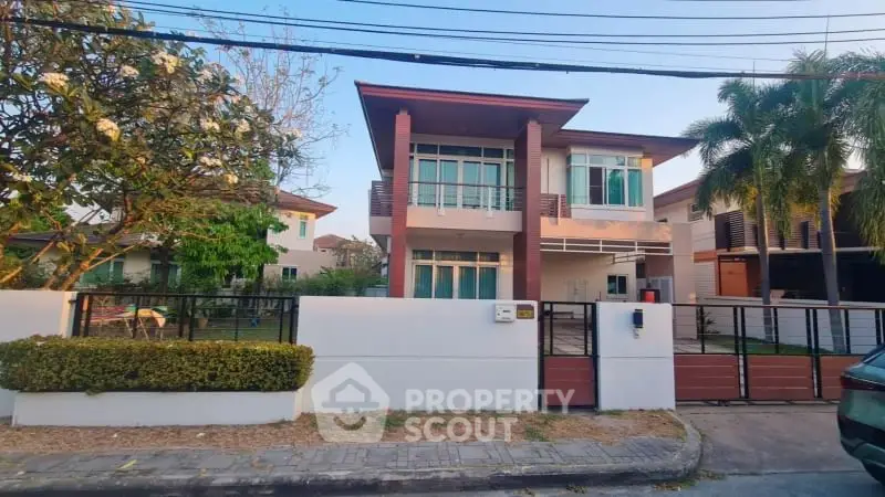 Modern two-story house with spacious front yard and gated entrance