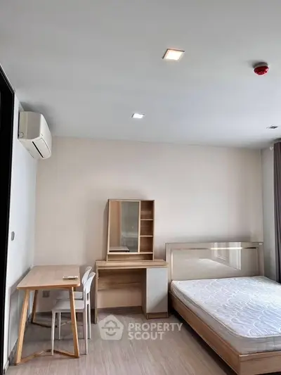 Modern minimalist bedroom with wooden furniture and natural light