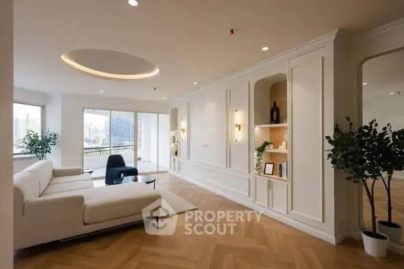 Spacious modern living room with elegant decor and large windows offering city views.