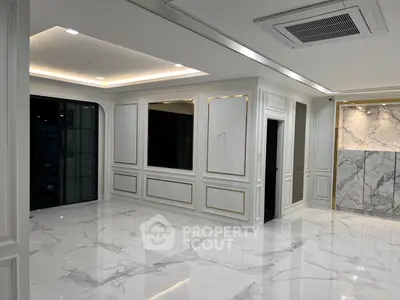 Luxurious modern interior with marble flooring and elegant wall paneling, perfect for upscale living.