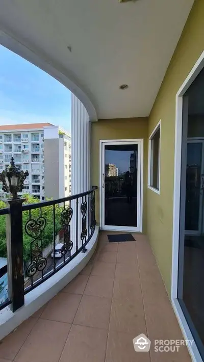 Spacious balcony with elegant railing and city view, perfect for relaxation and enjoying the outdoors.