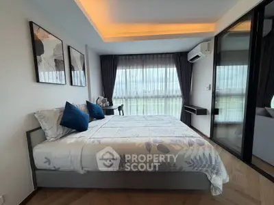 Modern bedroom with large windows and stylish decor in a luxury apartment.
