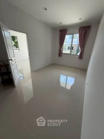 Spacious empty room with glossy tiled floor and large window, ideal for customization.