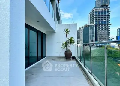 Spacious balcony with city view in modern high-rise building