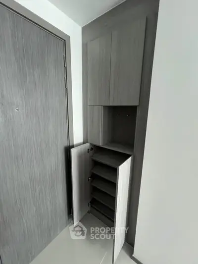 Modern storage cabinet in sleek apartment entryway with minimalist design.