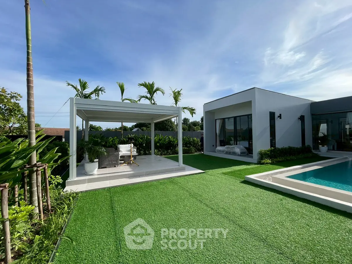 Luxurious modern villa with private pool and lush garden, perfect for relaxation and entertaining.