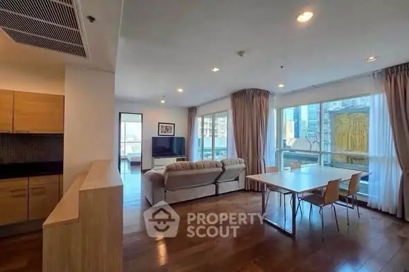 Spacious modern living room with large windows and wooden flooring