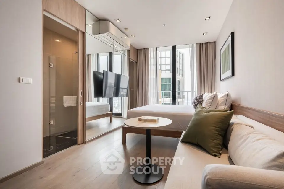 Modern bedroom with floor-to-ceiling windows and stylish decor