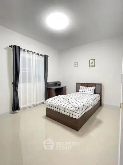 Modern minimalist bedroom with single bed and sleek furniture