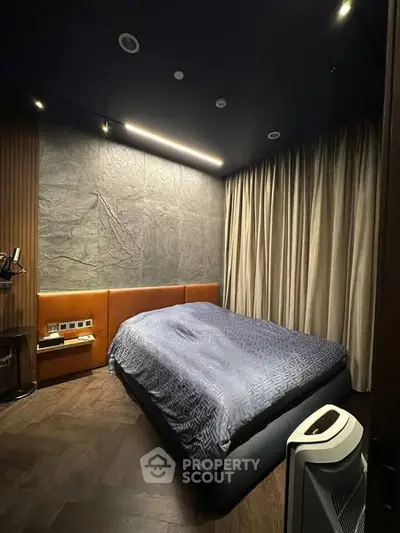 Luxurious modern bedroom with stylish lighting and cozy bedding