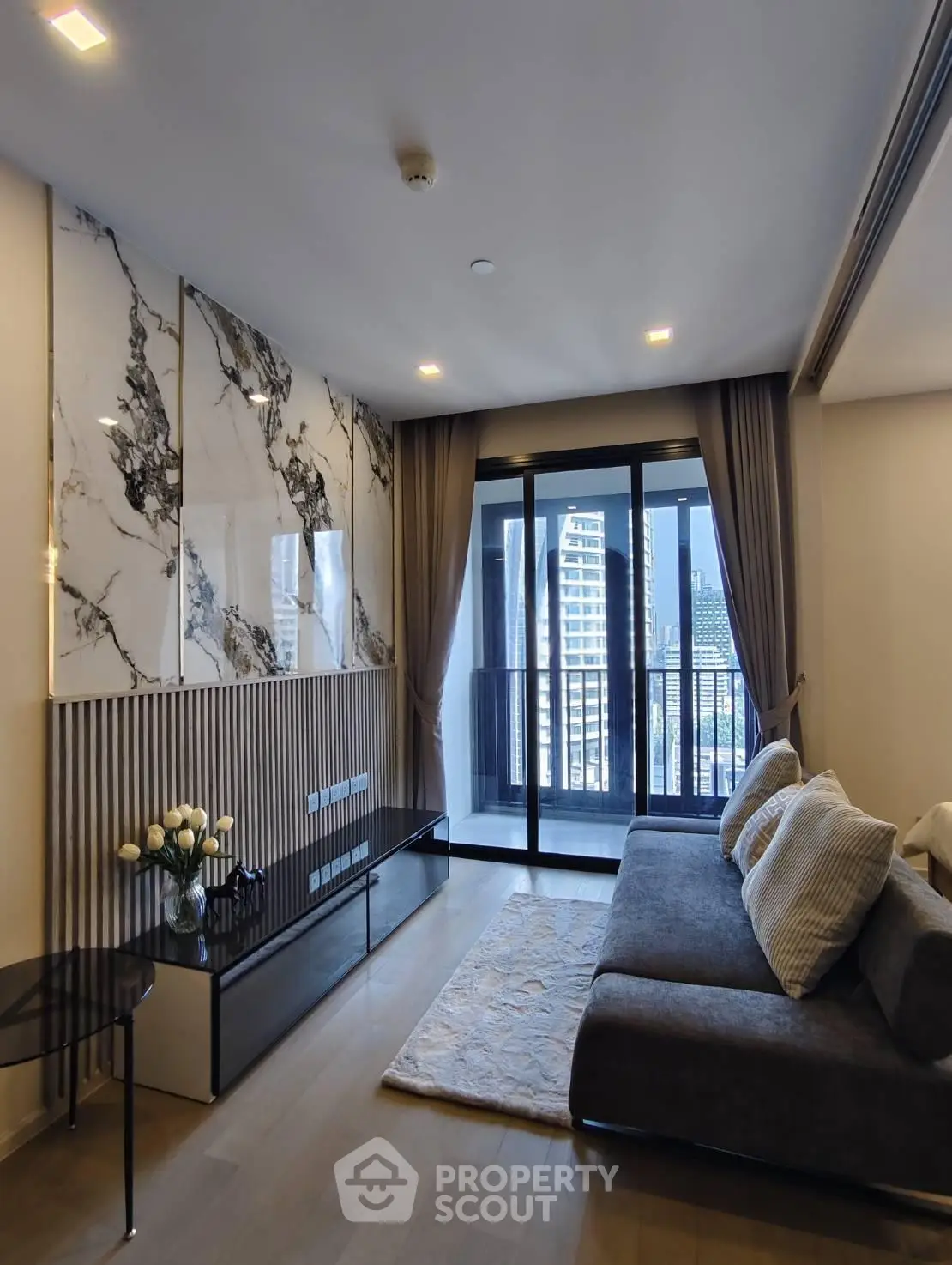 Luxurious modern living room with marble accents and city view balcony