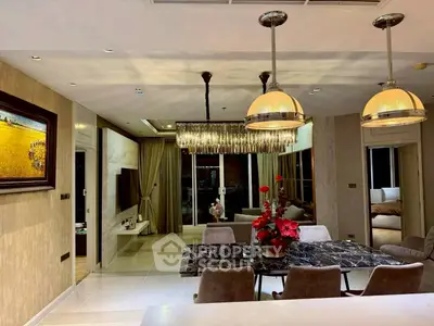 Luxurious open-plan living and dining area with elegant lighting and modern decor.